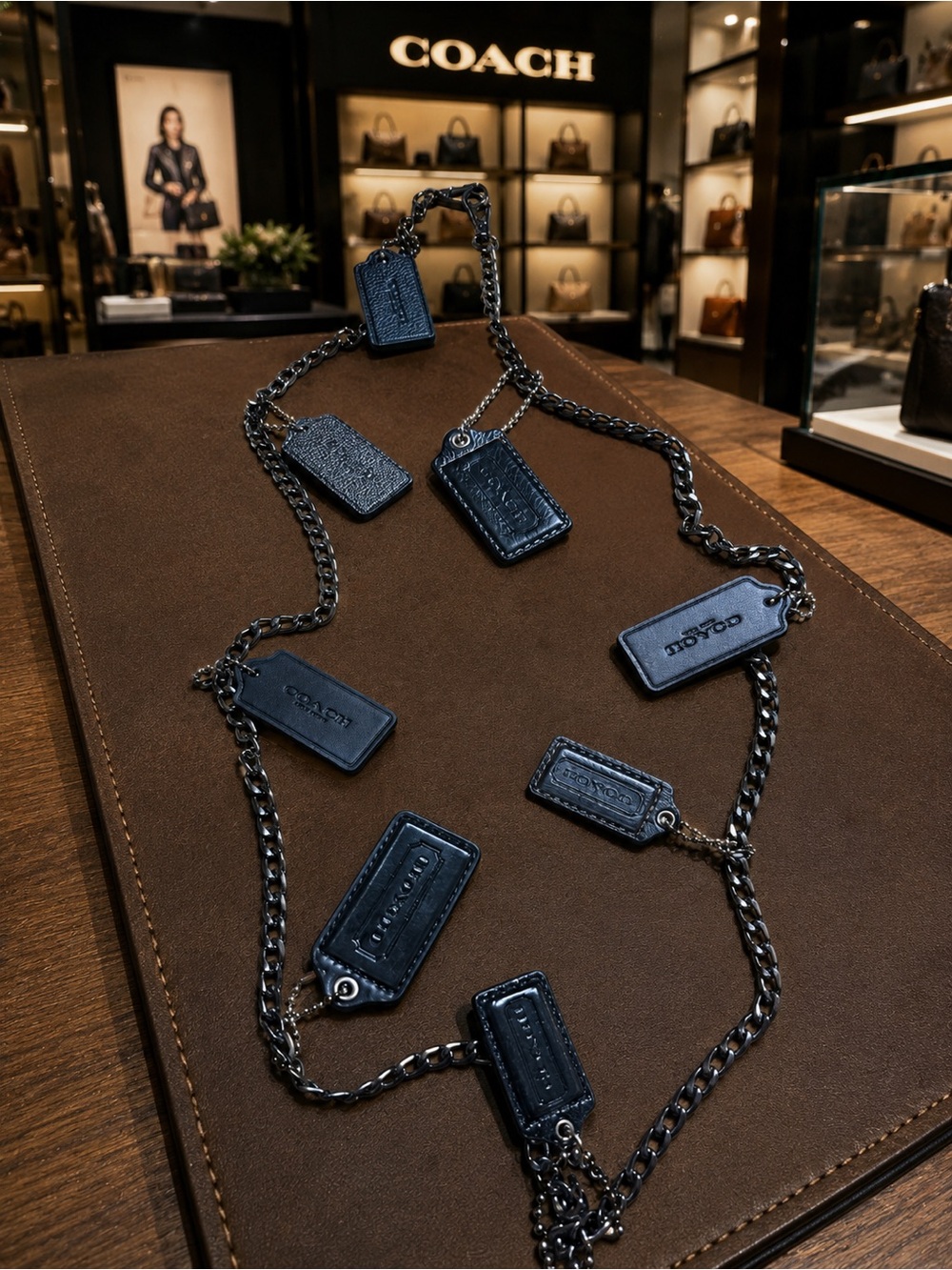 Coach hanging hang tags (8) from a Gunmetal Chain Strap